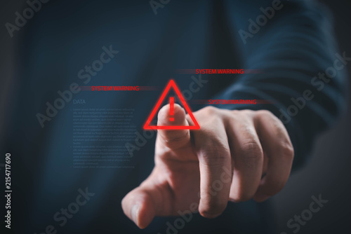 Bild auf Leinwand Cybersecurity warning featuring a hand pressing a digital alert icon, representing system security, cyber threat detection, risk management, data protection, network monitoring, incident response
