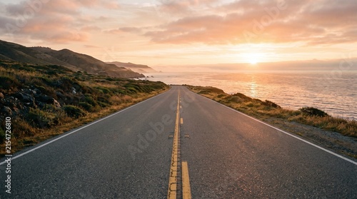 Scenic coastal highway stretching toward the horizon during a warm sunset