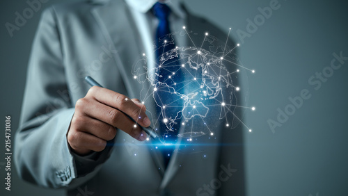 Businessman holding pen pointing at digital global network connection concept for worldwide business communication, corporate technology, cyber data transfer and international trade.
