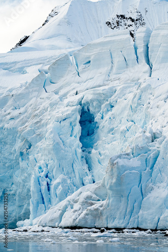 Large Glacial Crevasses on an Iceberg or Glacier Calving into the Ocean During an Antarctic Expedition