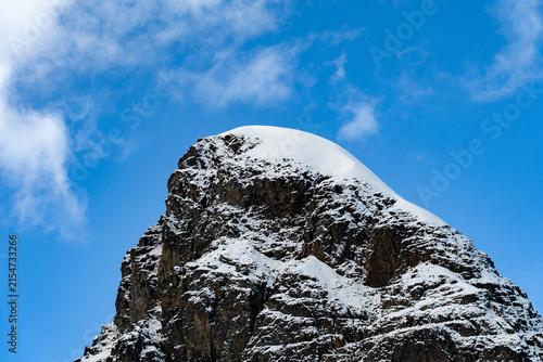 Antarctic expedition. Mountain peak covered in snow against a blue sky