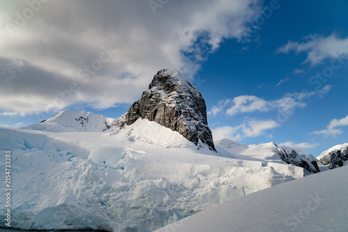  icy landscape of an Antarctic expedition with snow-covered mountains and bright blue sky
