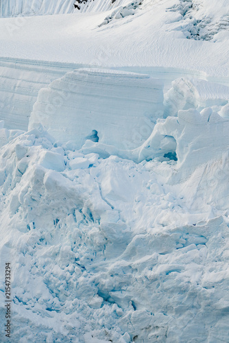 Large Glacial Crevasses on an Iceberg or Glacier Calving into the Ocean During an Antarctic Expedition