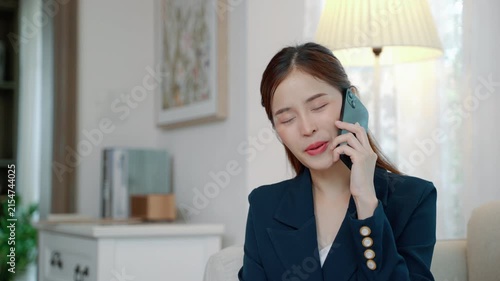 Professional woman talking on a smartphone while sitting at home, representing communication, business calls, remote work, and modern lifestyle.
