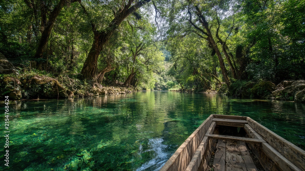 Fototapeta premium A tranquil boat journey down a clear river surrounded by lush, vibrant green forest. The water's surface reflects the dense foliage, creating a sense of serenity and immersion in nature