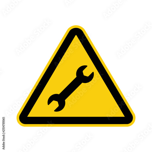 Yellow triangle warning sign with wrench tool icon.