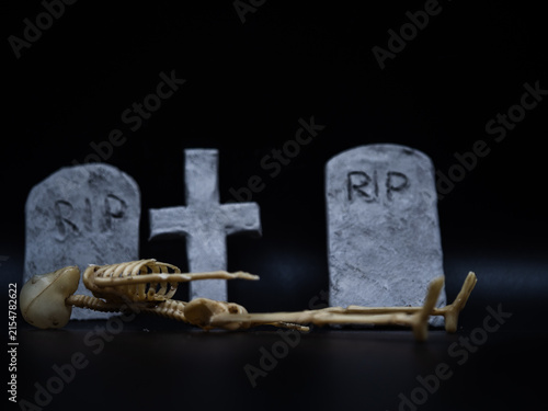 Skeleton in Halloween cemetery black background