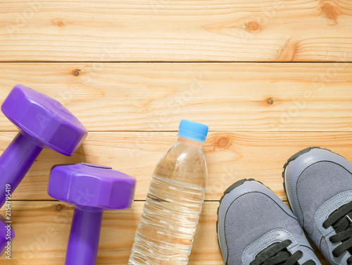 Exercise and fitness equipment on wooden background