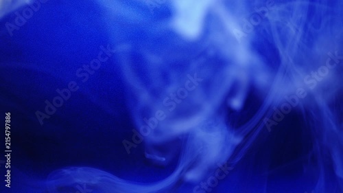 Blue swirls of smoke on black background