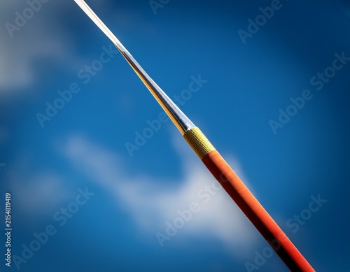 a close up of a javelin slicing through the sky leaving a blurred trail during a national competition