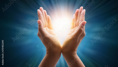 open hands holding bright healing light symbol of hope and care