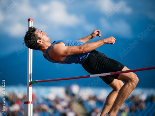 High Jumper Athlete Clearing Horizontal Bar During Track Competition