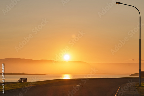Konstfotografi sunset on the bench at icelandic town