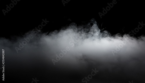 cinematic fog overlay with low hanging atmospheric haze and faint lighting isolated on a black background