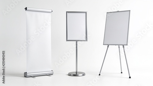 blank presentation boards against a white background. On the left is a retractable roll-up banner stand with a silver base and top, showcasing a smooth, white surface. In the center is a freestanding 