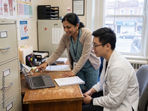 South Asian Mentor Reviewing Clinical Notes with East Asian Trainee