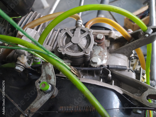 Cuadro en lienzo A close-up of a carburetor, revealing the complex system of hoses, fittings, and metal components