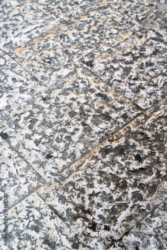 Textured granite stone surface with natural speckled pattern and diagonal crack line