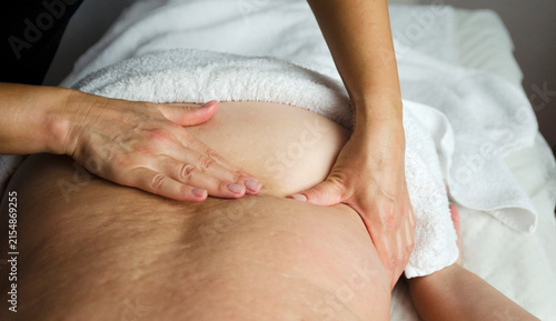 Obraz na płótnie Massage therapist performing a professional back massage with hands on a female client