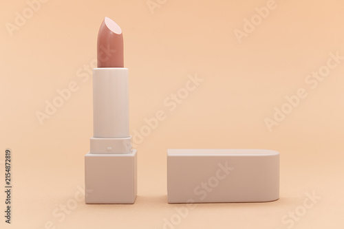 Beige lipstick on a beige background. In a beige case. Close-up.