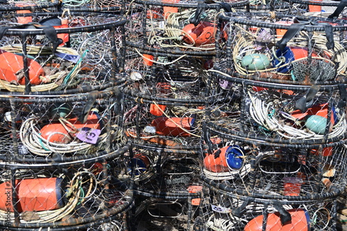 Close-up view of weathered fishing nets wrapped around round buoys, showing traditional commercial fishing equipment, rope, and maritime gear.