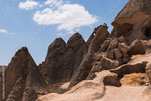 Quadro su tela Ancient volcanic rock formations and fairy chimneys under blue sky in Cappadocia