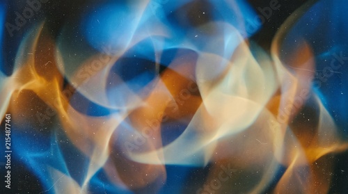 Abstract flowing blue and orange light patterns creating a dynamic and ethereal visual effect on a dark background.