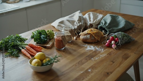 Zero waste grocery shopping with fresh organic produce and bread on kitchen counter