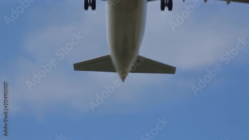 Commercial airplane taking off from airport runway against a clear blue sky