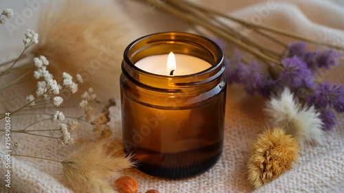 Amber Glass Scented Candle with Dried Flowers in Cozy Home Decor Setting