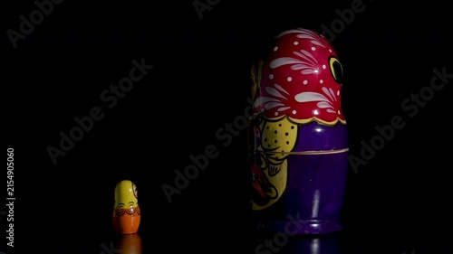 Spinning Matryoshka dolls on black background
