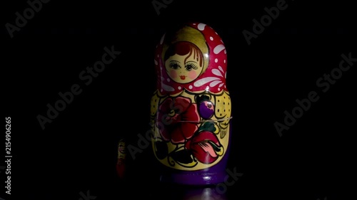 Spinning Matryoshka dolls on black background