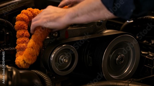 Mechanic Places Marigold Garland on Clean Car Engine