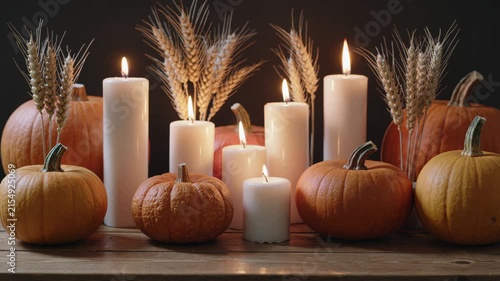 Autumnal thanksgiving decoration with pumpkins and candles burning