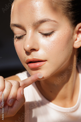 Quadro su tela Close-up of Woman Applying Acne Patch on Chin