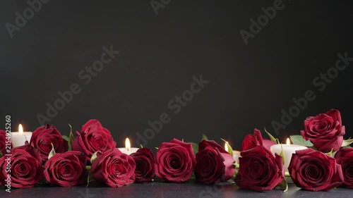 Romantic red roses and flickering candles border