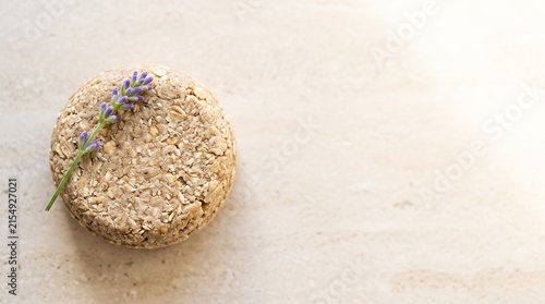 Natural shampoo bar with lavender flower on a light background  