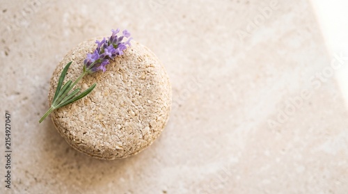 Natural soap bar with lavender and rosemary on a stone surface  