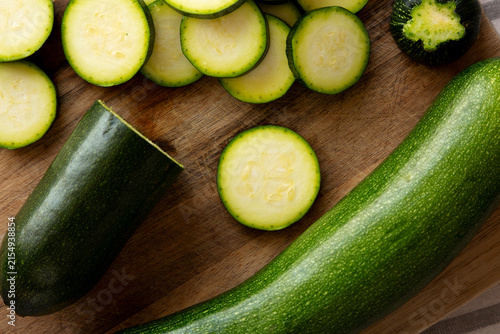 Fotografie Raw Green Organic Zucchini on a Wooden Board, top view