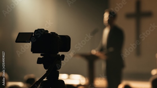 Livestream Sermon Production in Modern Church, Silhouette Camera and Preacher with Cross, Minimalist Symbolic Background