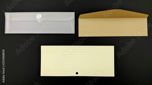 Three stationery items including plastic envelope, paper envelope and stack of cards