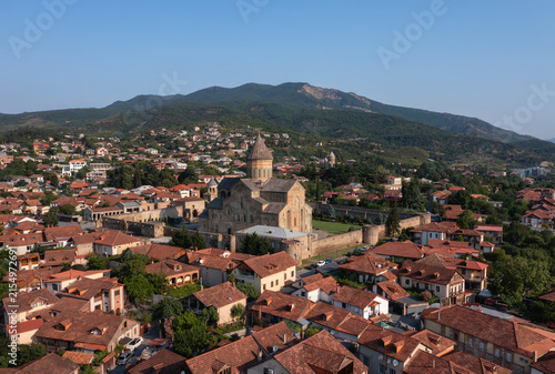 Scenic aerial panorama of Mtskheta in Georgia featuring Svetitskhoveli Cathedral, historic architecture, and lush mountain landscapes