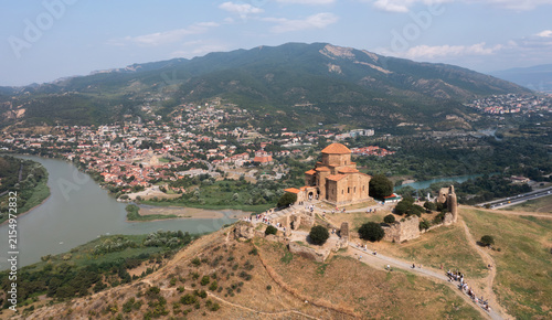 Aerial view of the ancient Jvari Monastery surrounded by mountains, rivers, and the town of Mtskheta, Georgia