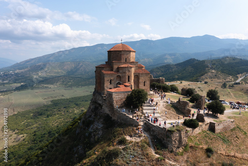 Scenic landscape of Mtskheta featuring ancient Jvari Monastery, a river, and green mountain slopes