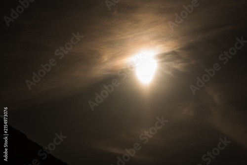Partial solar eclipse forming a glowing sun crescent over city rooftop silhouettes at night in Kiel Germany Baltic Sea 2026 