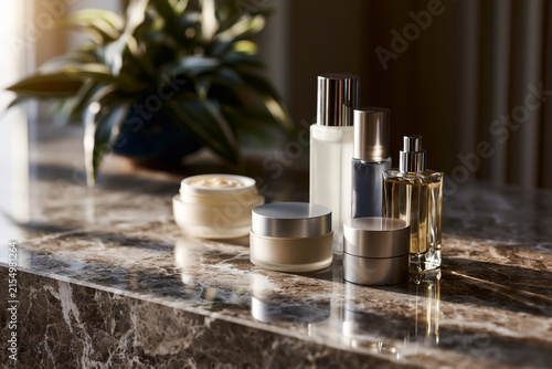 Spectacular and vivid representation of Sophisticated vanity arrangement with blank cream jars and frosted glass bottles, polished limestone surface, refined editorial styling,, offering a unique and