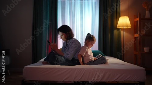 mother and small child use smartphones in the evening ,problems of family communication
