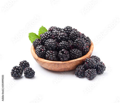 Blackberry fruits in wooden plate on white backgrounds
