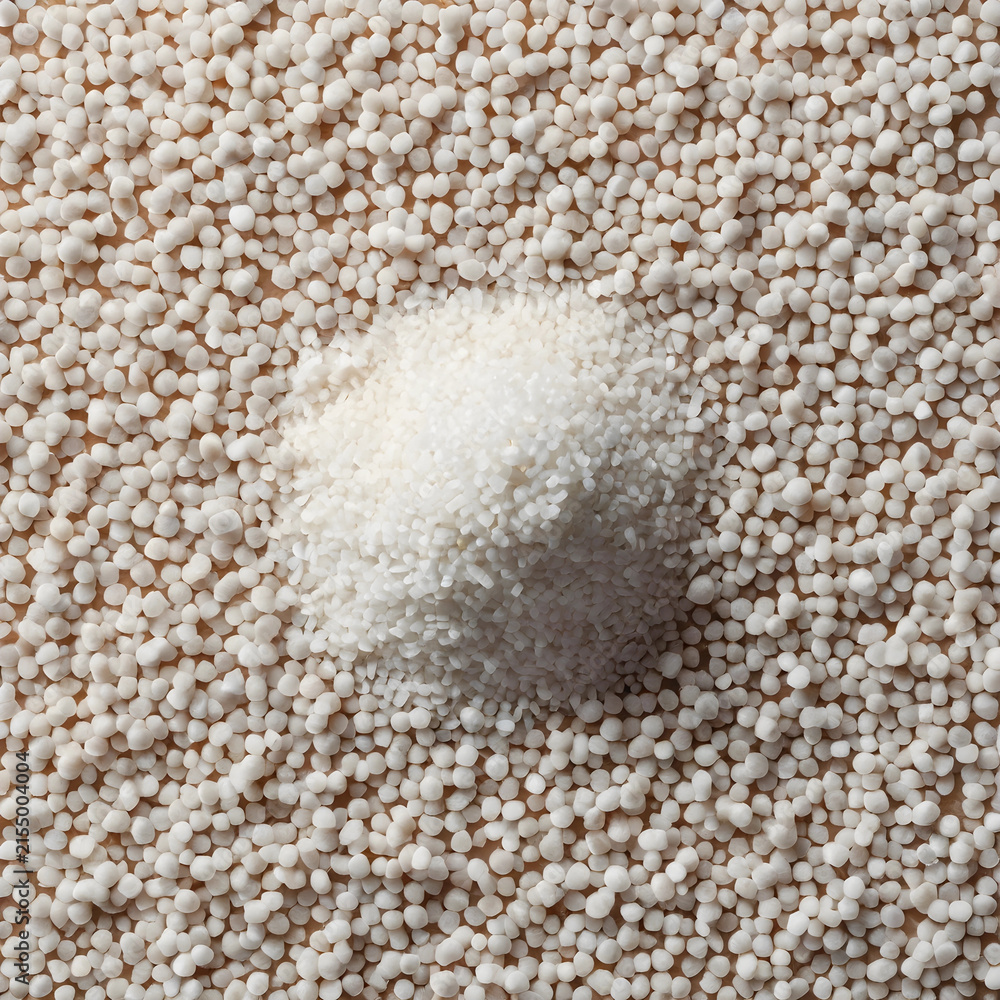 Fototapeta premium White granular fertilizer pile on a background of smaller white pellets, agriculture and plant nutrition