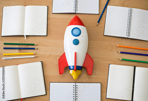 Red and white toy rocket su...